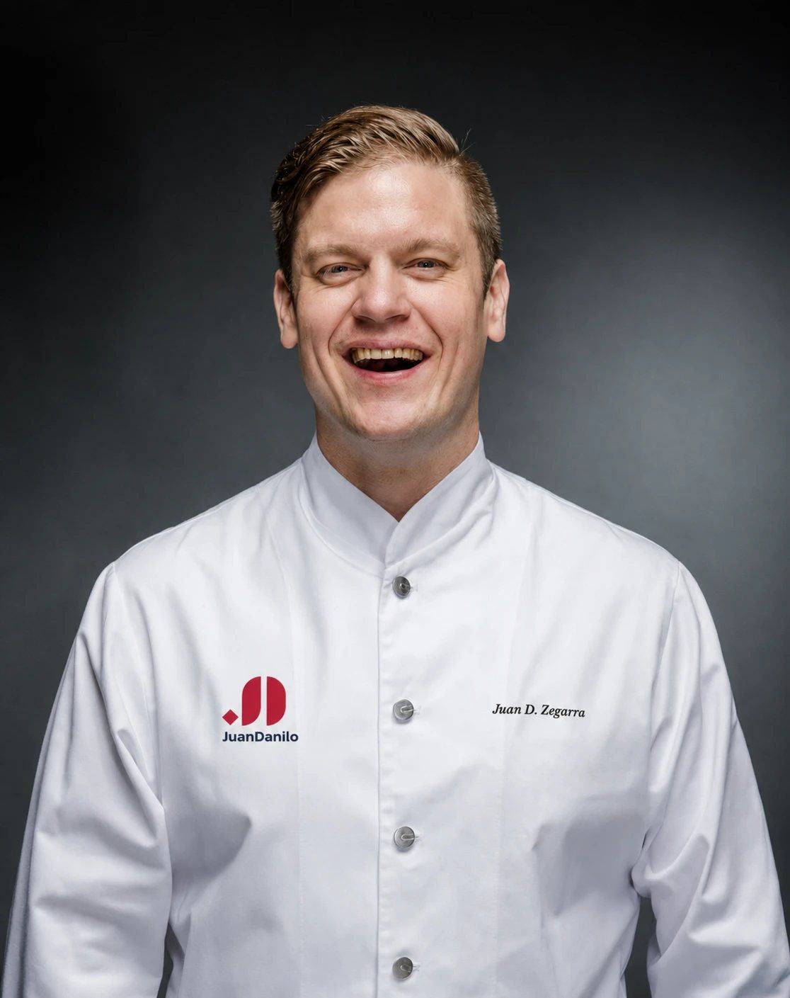 Juan Danilo Zegarra Presser laughing, in chef's whites